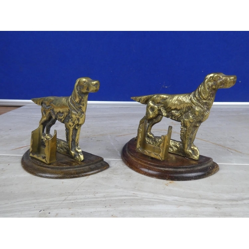 906 - A pair of brass dog ornaments with matchbox holders.