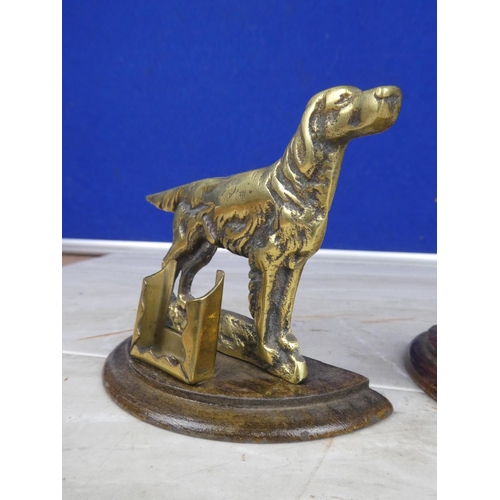 906 - A pair of brass dog ornaments with matchbox holders.