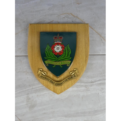 927 - A wooden shield wall plaque 'Intelligence Corps'. 18cm.