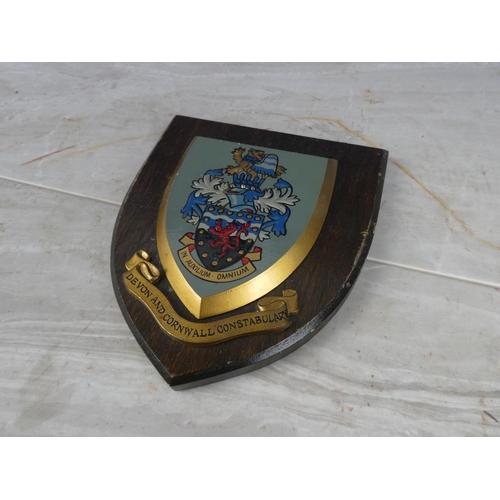 929 - A wooden shield wall plaque 'Devon and Cornwall Constabulary'. 18cm.