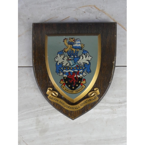 929 - A wooden shield wall plaque 'Devon and Cornwall Constabulary'. 18cm.