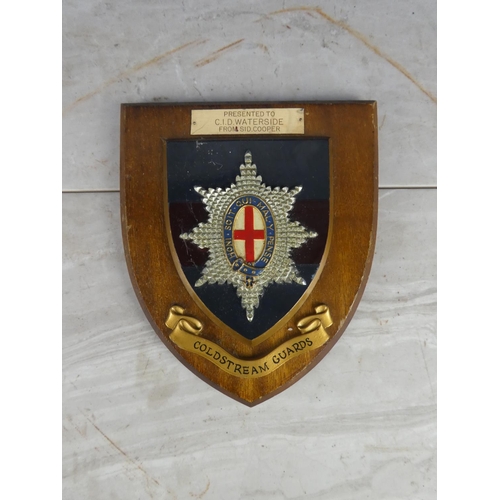 932 - A wooden shield wall plaque 'Coldstream Guards - Presented to CID Waterside from Sid Cooper'.17cm.