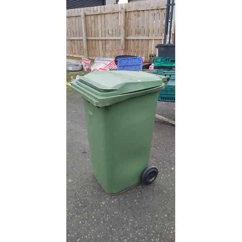 958 - A green wheelie bin.