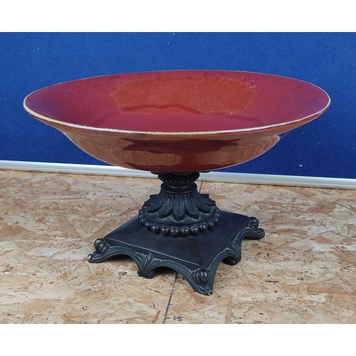 1381 - A red ceramic bowl on decorative metal base.