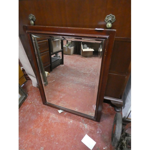 1254 - A mahogany framed bevelled glass wall mirror.