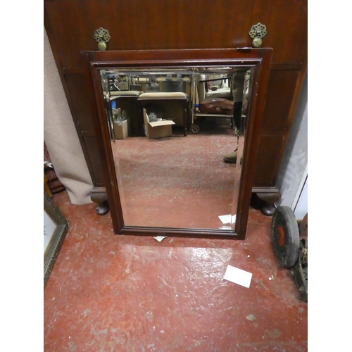 1254 - A mahogany framed bevelled glass wall mirror.