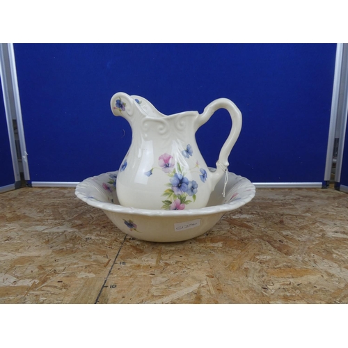 1279 - A floral patterned jug and basin set.