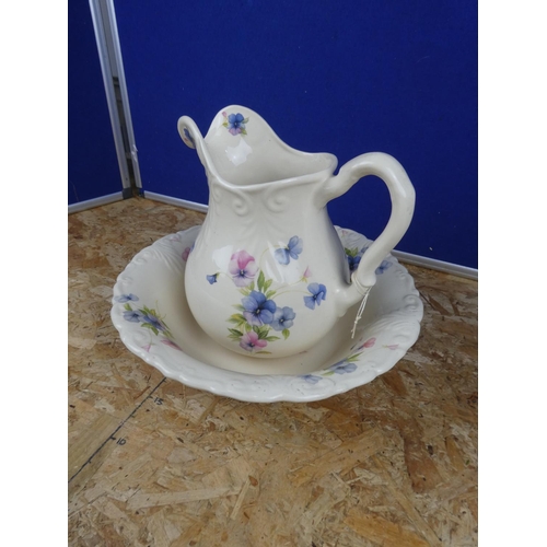 1279 - A floral patterned jug and basin set.