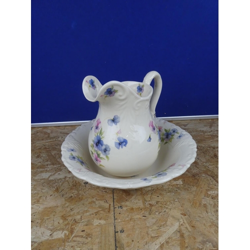 1279 - A floral patterned jug and basin set.