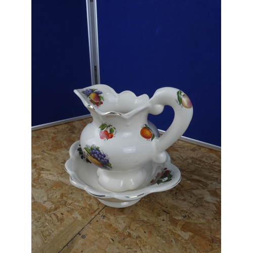 1281 - A ceramic jug and basin set.