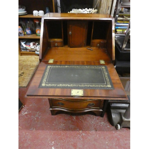 1292 - A stunning small bow fronted writing bureau with key.