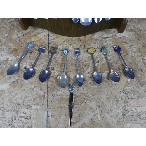 1309 - A large assortment of souvenir spoons with wall mountable display unit.