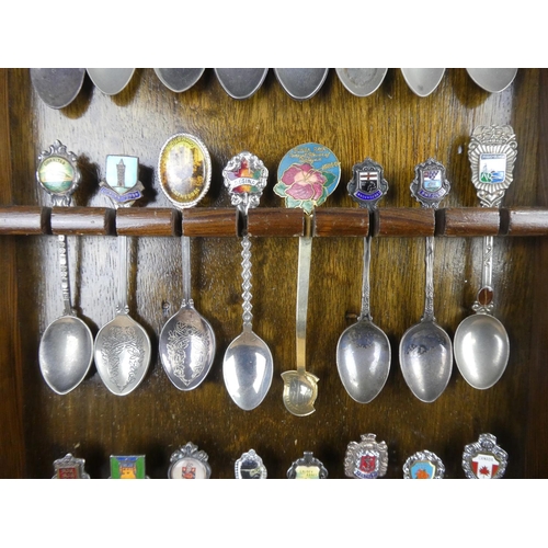 1309 - A large assortment of souvenir spoons with wall mountable display unit.