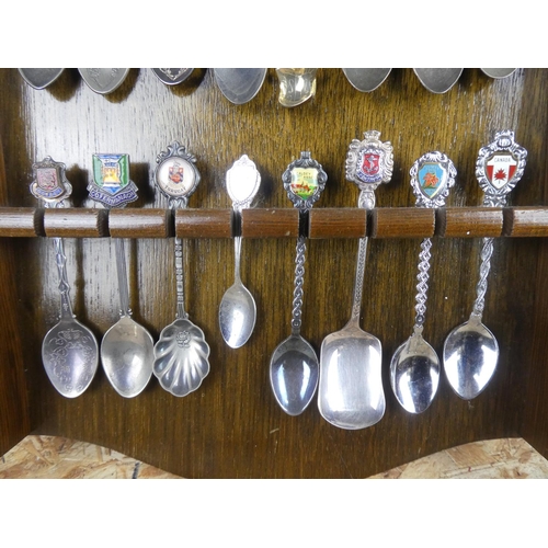 1309 - A large assortment of souvenir spoons with wall mountable display unit.