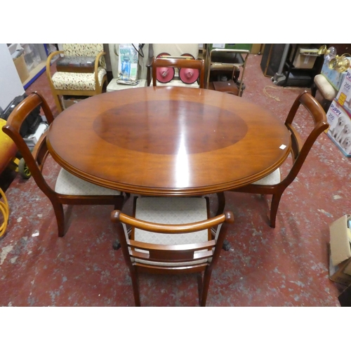 1367 - A stunning oval dining room table and four upholstered chairs.