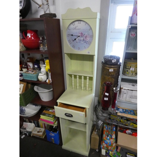 128 - An unusual slimline painted display unit with clock. Approx 187cm.
