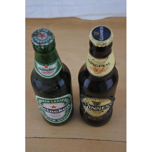 234 - An unopened bottle of Heineken beer and a bottle of Guinness (seal broken).
