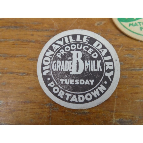 300 - A collection of vintage Monaville Dairy, Portadown & Uppertown Diary Farm, Larne milk bottle tops an... 