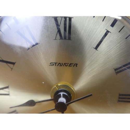 382 - A vintage Stagier Quartz onyx cased mantle clock on brass feet.