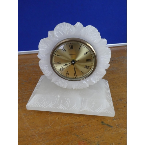 382 - A vintage Stagier Quartz onyx cased mantle clock on brass feet.