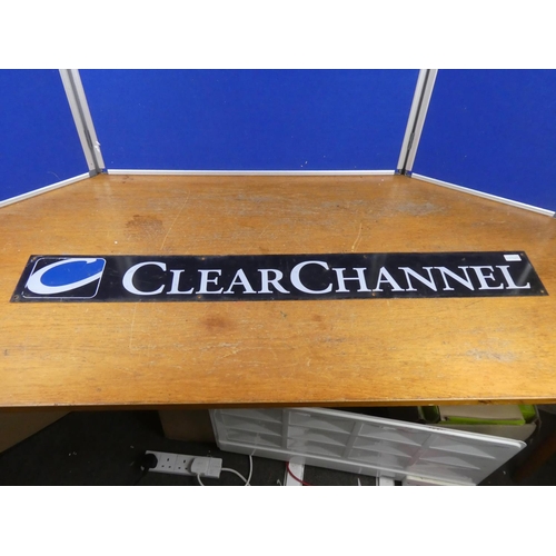 392 - A vintage 'Clear Channel' metal advertising sign. Approx 124x15cm.