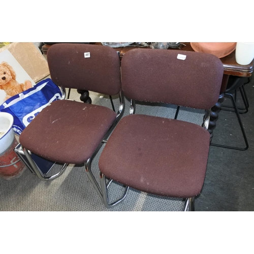 497 - A pair of vintage upholstered chairs on metal frames.