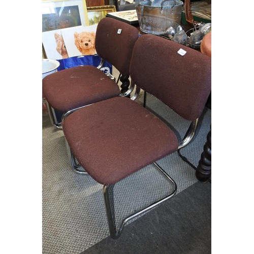 497 - A pair of vintage upholstered chairs on metal frames.