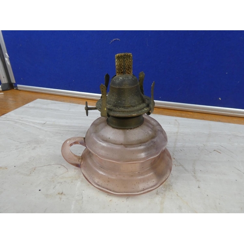 18 - An antique pink glass finger lamp.