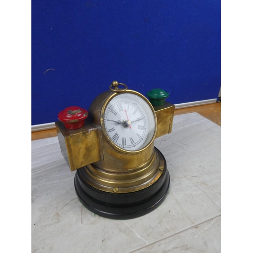 27 - An unusual brass mantle clock in the style of a ships binnacal compass.