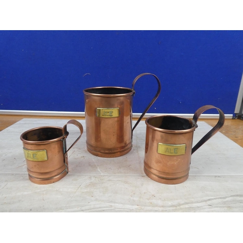 32 - A set of three vintage copper and brass 'Ale' measures.