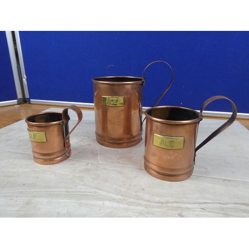 32 - A set of three vintage copper and brass 'Ale' measures.