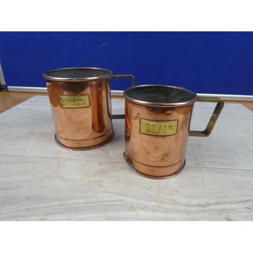 43 - A pair of vintage copper and brass 'Grain' measures.