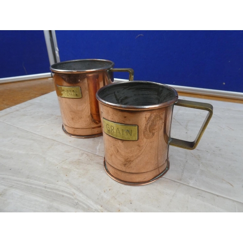 43 - A pair of vintage copper and brass 'Grain' measures.