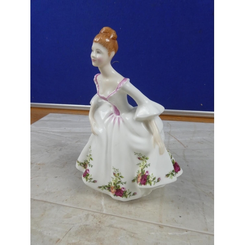 73 - A Royal Doulton figure, 'Country Rose'.