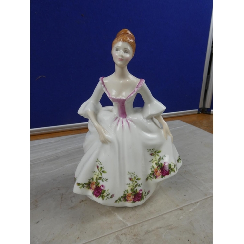 73 - A Royal Doulton figure, 'Country Rose'.