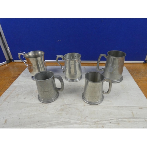 8 - An assortment of four pewter tankards and another.