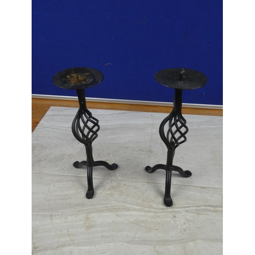 85 - A pair of wrought iron candlesticks.