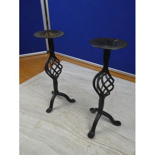 85 - A pair of wrought iron candlesticks.