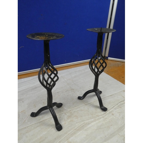 85 - A pair of wrought iron candlesticks.