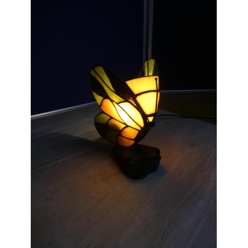 582 - A leaded glass table lamp in the style of a butterfly.