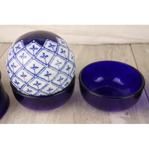 671 - A blue and white ceramic ball and a lot of blue glass and pottery ware.