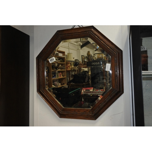 684 - An oak framed hexagonal wall mirror. Approx 52cm dia.