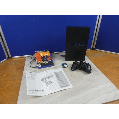 702 - A Playstation 2 console, controller, instruction manual and Pro Evolution Soccer 3 game.