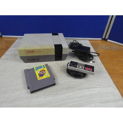 706 - A Nintendo Entertainment System Nes Version console, with control pad & Super Mario 3 cartridge.