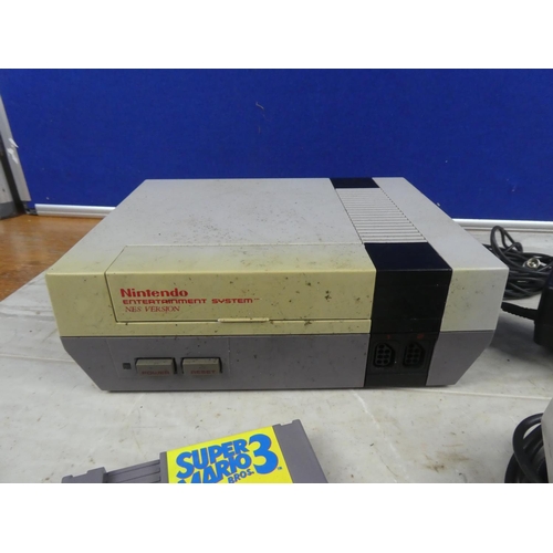 706 - A Nintendo Entertainment System Nes Version console, with control pad & Super Mario 3 cartridge.