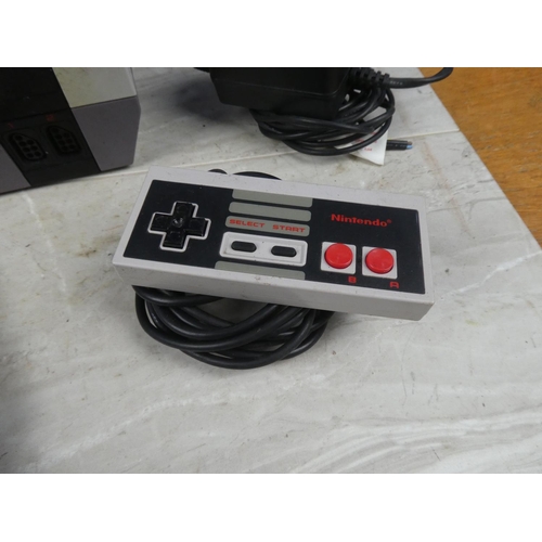 706 - A Nintendo Entertainment System Nes Version console, with control pad & Super Mario 3 cartridge.