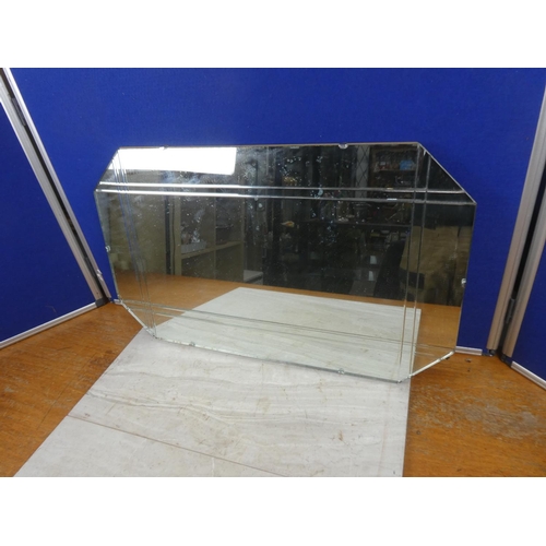 714 - A vintage frameless mirror. Approx 69x41cm.