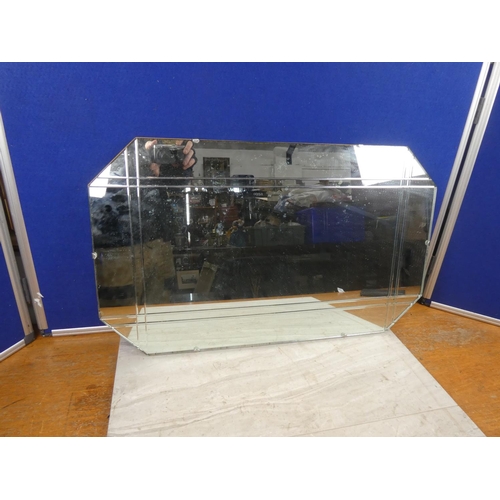 714 - A vintage frameless mirror. Approx 69x41cm.