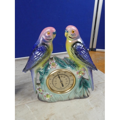 715 - A vintage Polaris ornamental mantle clock decorated with birds and another of a thermometer.