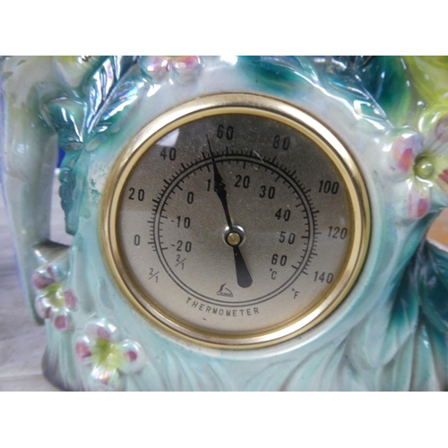 715 - A vintage Polaris ornamental mantle clock decorated with birds and another of a thermometer.